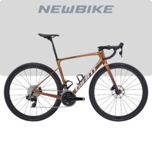 Orange gradient road bicycle with drop handlebars, black saddle, and water bottle cages, mounted with disc brakes on front and rear.