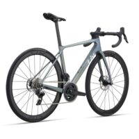 Road bike with a gray-blue carbon frame, drop handlebars, and large gear cassette on a white background.