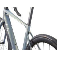 Close-up of a metallic blue road bike frame near the seatpost and rear wheel.