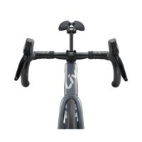 Front view of a road bike cockpit with drop handlebars, brake/shift levers, and a gray frame showing a partial logo on the downtube.