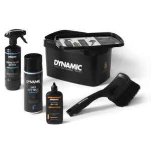 Dynamic car detailing kit with spray bottle, foam cleaner, two lubricant bottles, a black cleaning bucket, and a large brush/duster set.